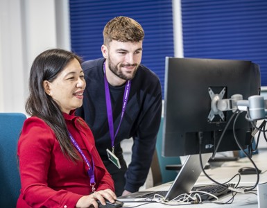 2 Finance colleagues working together at laptop