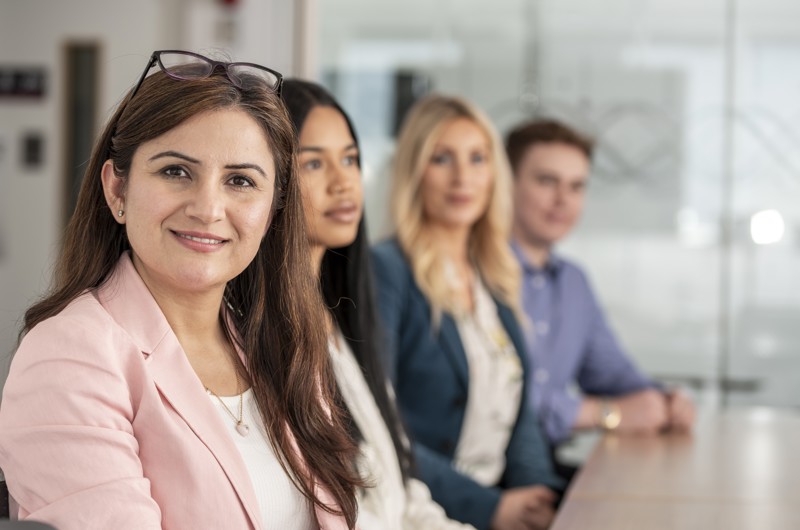 Mix of employees with one looking to camera