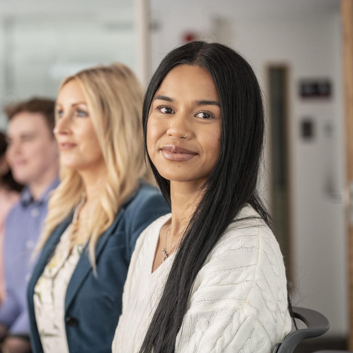 Group of employees sitting in a line