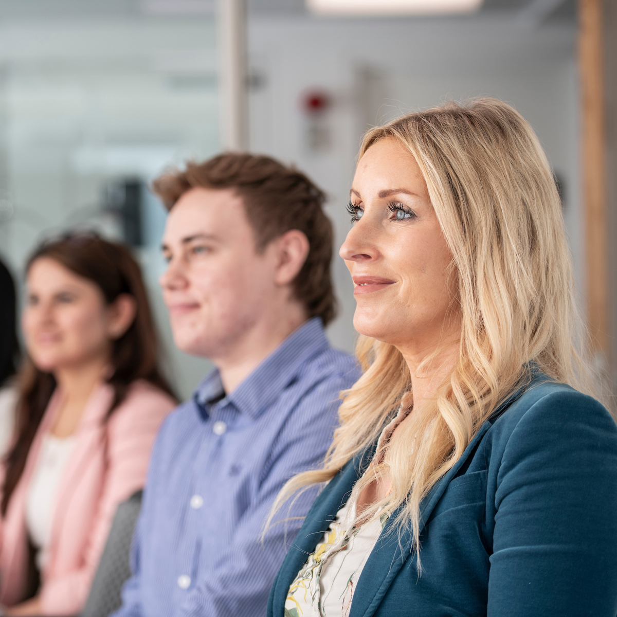 Group of employees sitting in line